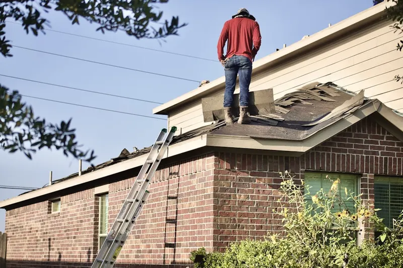 Professional roofer working on a residential roof in Pardue Mill